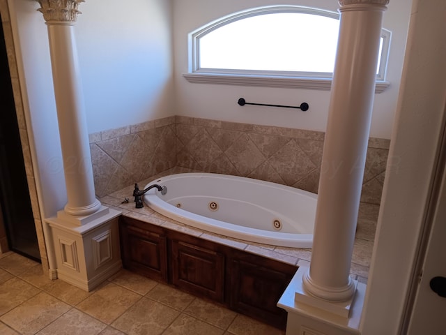 bathroom featuring a jetted tub and ornate columns