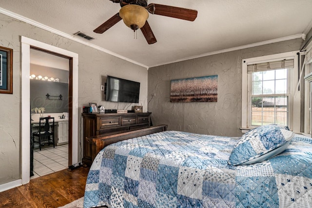 1203 Lee St, Borger, TX 79007 - bedroom with a textured wall, wood finished floors, crown molding, a ceiling fan, and baseboards