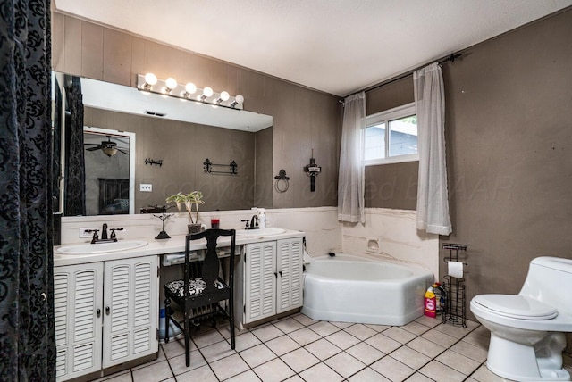 1203 Lee St, Borger, TX 79007 - bathroom with tile patterned floors, a garden tub, toilet, and double vanity