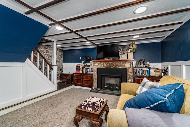 1203 Lee St, Borger, TX 79007 - carpeted living room featuring recessed lighting, a wainscoted wall, coffered ceiling, a fireplace, and stairs