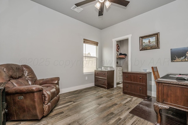 sitting room featuring dark wood finished floors, visible vents, a ceiling fan, and baseboards
