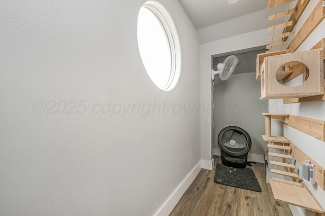 interior space with baseboards and wood finished floors