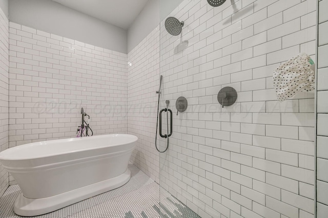full bath featuring a tile shower, tile walls, a soaking tub, and tile patterned flooring