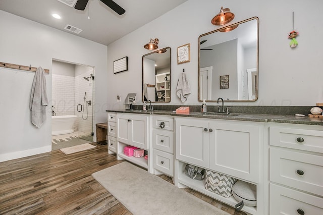 bathroom with wood finished floors, visible vents, a sink, and a ceiling fan
