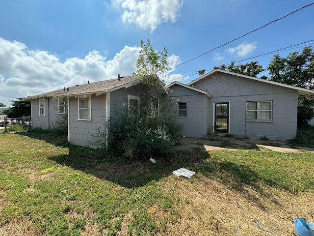 rear view of property with a lawn