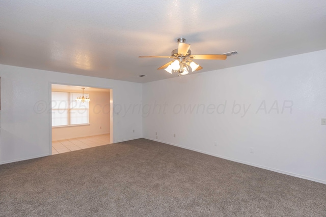 unfurnished room featuring light colored carpet and ceiling fan with notable chandelier