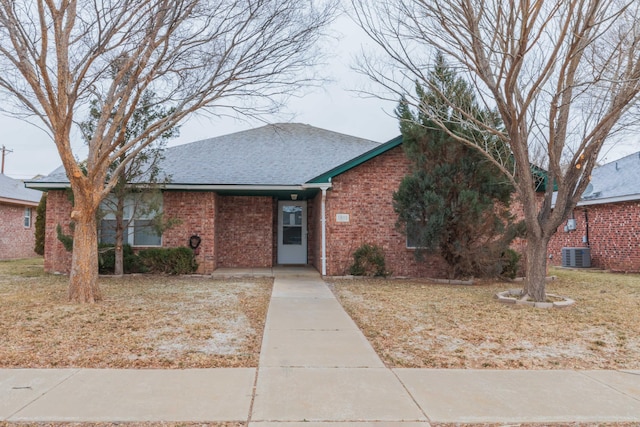 single story home featuring central AC and a front yard