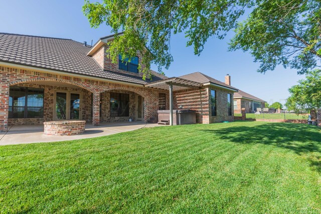 3 Country Club Dr, Amarillo, TX 79124 - rear view of house with a hot tub, a patio area, and brick siding