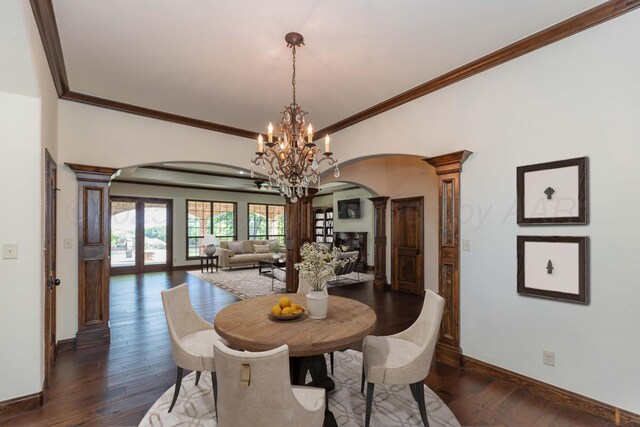 3 Country Club Dr, Amarillo, TX 79124 - dining room with ornate columns, arched walkways, a chandelier, dark wood-type flooring, and crown molding