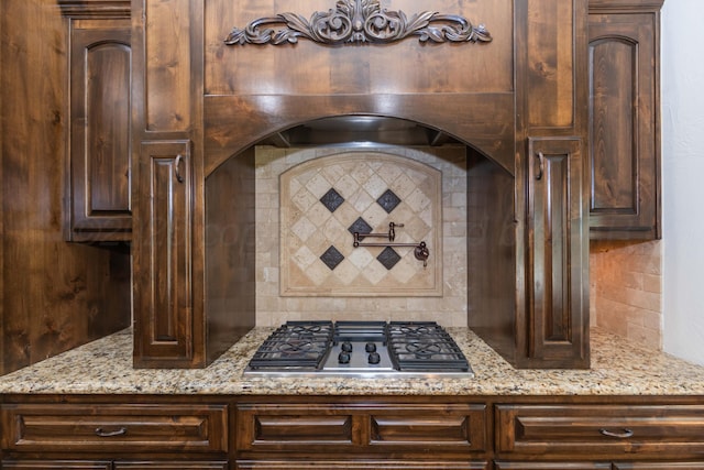 3 Country Club Dr, Amarillo, TX 79124 - kitchen view of stainless steel gas cooktop, pot filler, tasteful backsplash, and light stone counters