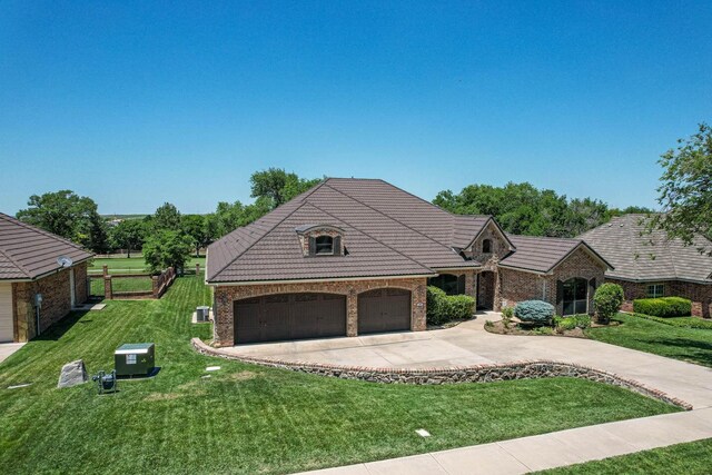 3 Country Club Dr, Amarillo, TX 79124 - french country style house featuring concrete driveway, brick siding, a garage, and a tiled roof