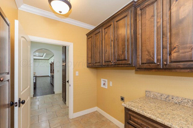 3 Country Club Dr, Amarillo, TX 79124 - washroom featuring cabinet space, ornamental molding, electric dryer hookup, hookup for a washing machine, and arched walkways