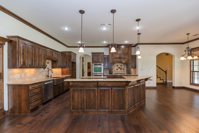 3 Country Club Dr, Amarillo, TX 79124 - kitchen with arched walkways, appliances with stainless steel finishes, dark brown cabinets, crown molding, and tasteful backsplash