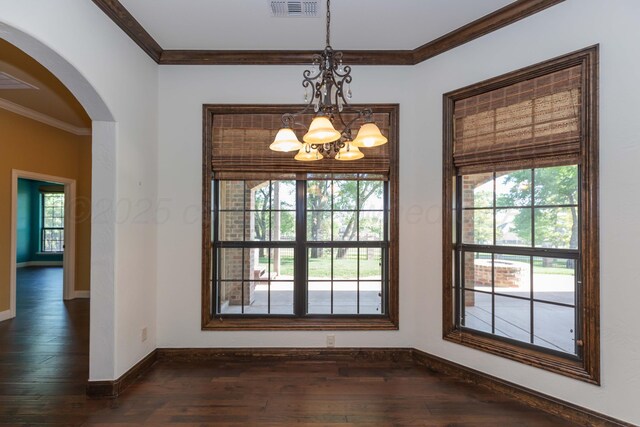 3 Country Club Dr, Amarillo, TX 79124 - unfurnished dining area featuring arched walkways, a chandelier, dark wood finished floors, and ornamental molding