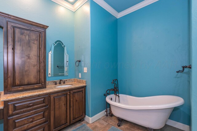 3 Country Club Dr, Amarillo, TX 79124 - bathroom featuring crown molding, a freestanding tub, vanity, and tile patterned flooring