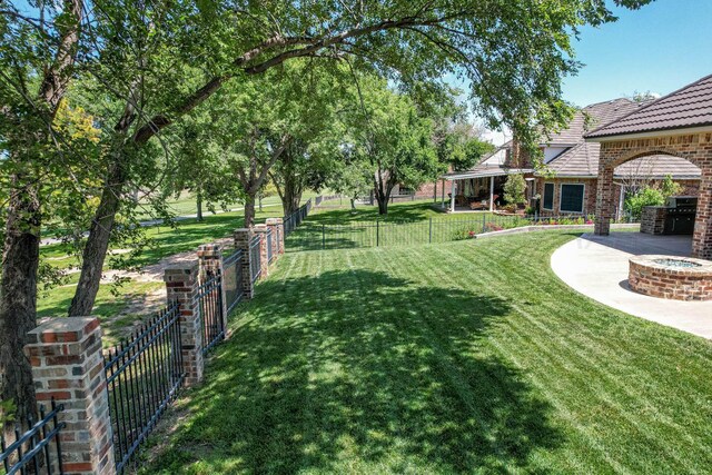 3 Country Club Dr, Amarillo, TX 79124 - fenced backyard featuring an outdoor fire pit and a patio area