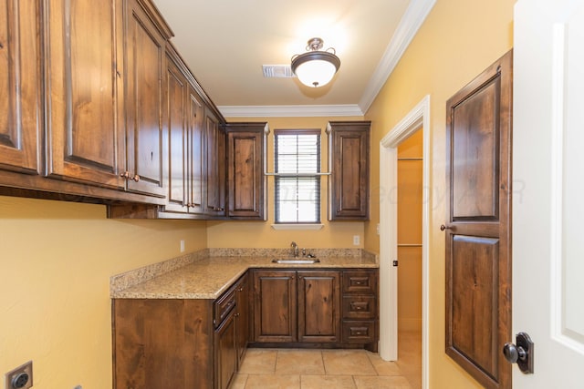 3 Country Club Dr, Amarillo, TX 79124 - kitchen featuring light tile patterned flooring, light stone counters, crown molding, and dark brown cabinetry