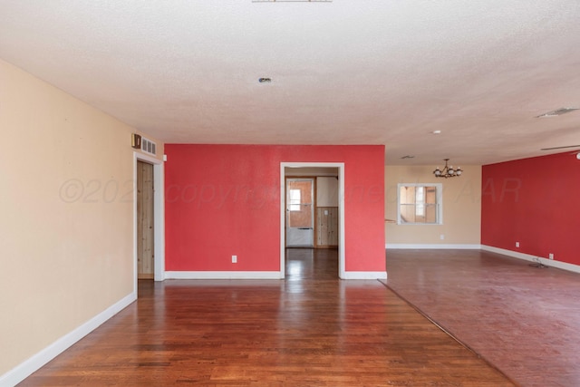 925 W Colorado Ave, Amarillo, TX 79108 - spare room featuring wood finished floors, a chandelier, baseboards, and a textured ceiling