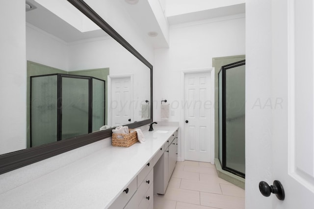 bathroom featuring walk in shower, tile patterned flooring, vanity, and ornamental molding