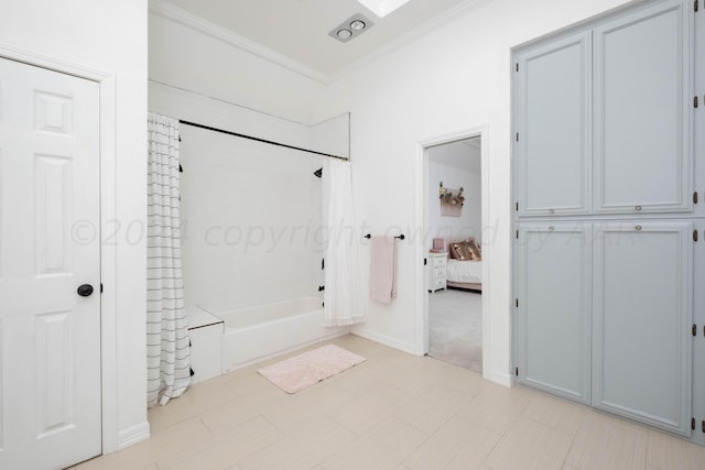 bathroom featuring ornamental molding and shower / bath combination with curtain