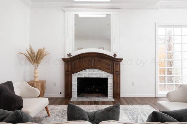 living room with a wealth of natural light, crown molding, and hardwood / wood-style flooring