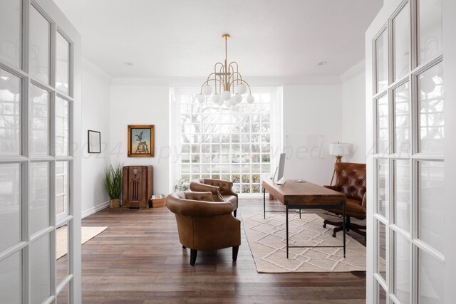 sitting room featuring wood-type flooring, ornamental molding, french doors, and a notable chandelier