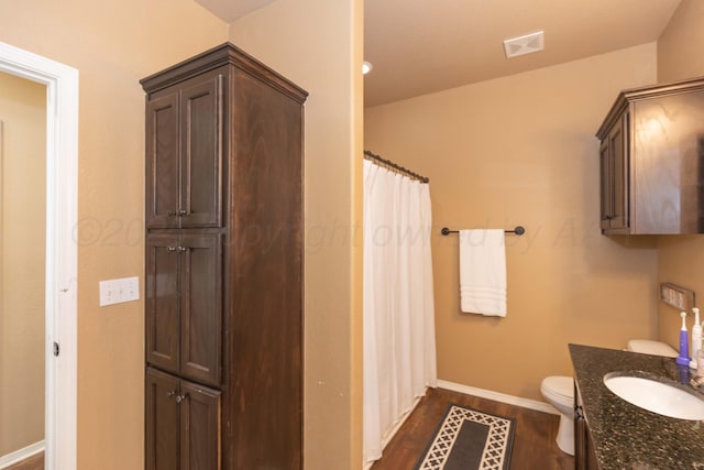 7116 Bennett St, Amarillo, TX 79119 - bathroom with wood finished floors, baseboards, toilet, vanity, and a shower with curtain