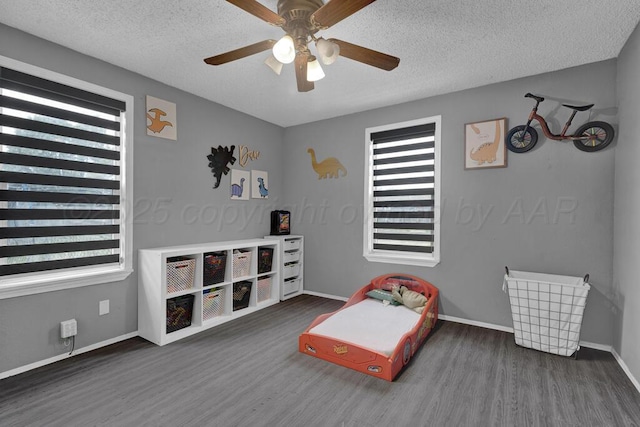 4215 S Tyler St, Amarillo, TX 79110 - bedroom featuring multiple windows, wood finished floors, a textured ceiling, and ceiling fan