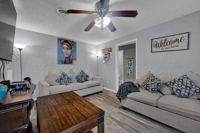 4215 S Tyler St, Amarillo, TX 79110 - living area with a textured ceiling, wood finished floors, and a ceiling fan