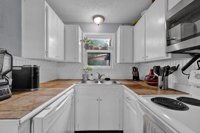 4215 S Tyler St, Amarillo, TX 79110 - kitchen featuring white appliances, tile countertops, white cabinetry, backsplash, and a textured ceiling