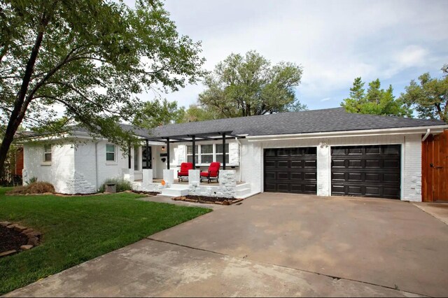 2406 Anna St, Amarillo, TX 79106 - single story home with brick siding, an attached garage, driveway, a front yard, and a pergola