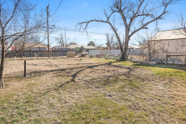 view of yard featuring fence and an outdoor structure