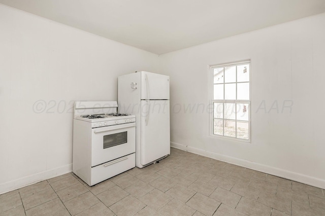 kitchen with white appliances, light tile patterned floors, baseboards, light countertops, and white cabinetry