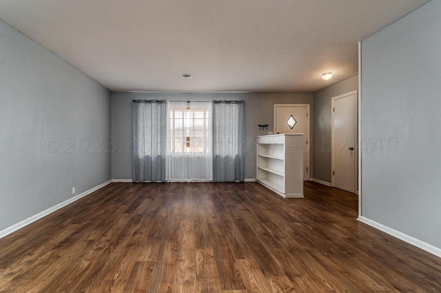 empty room with dark wood-type flooring