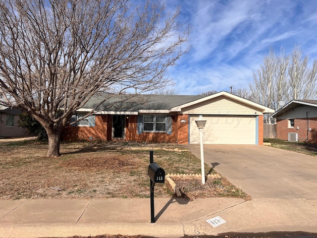 ranch-style home featuring brick siding, cooling unit, an attached garage, and driveway