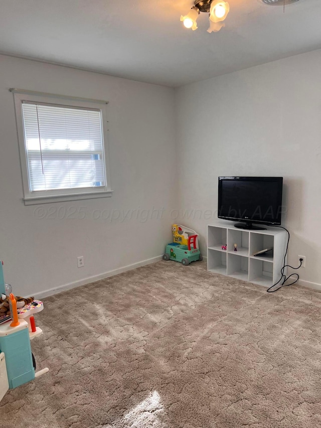 recreation room with carpet flooring and baseboards