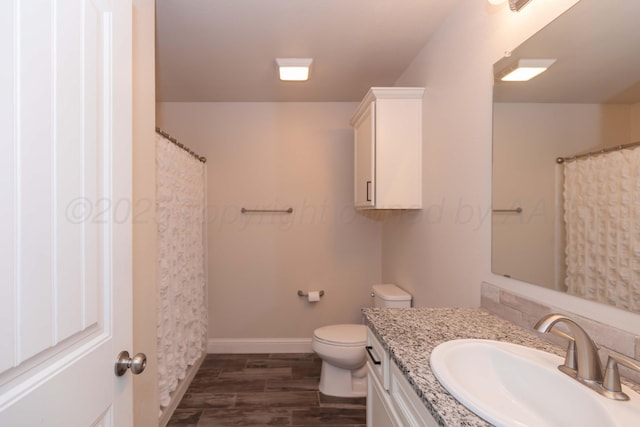 9310 Rockwood Dr, Amarillo, TX 79119 - bathroom featuring vanity, wood finished floors, curtained shower, toilet, and baseboards