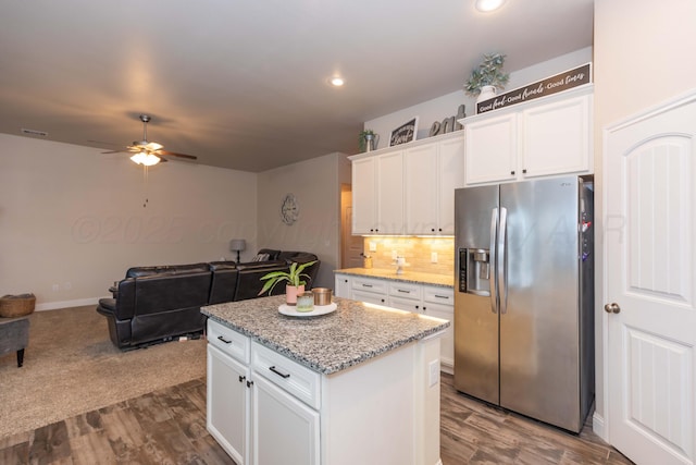9310 Rockwood Dr, Amarillo, TX 79119 - kitchen featuring decorative backsplash, stainless steel fridge, a center island, white cabinets, and a ceiling fan