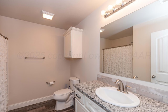 9310 Rockwood Dr, Amarillo, TX 79119 - full bathroom featuring vanity, wood finished floors, toilet, baseboards, and a shower with shower curtain