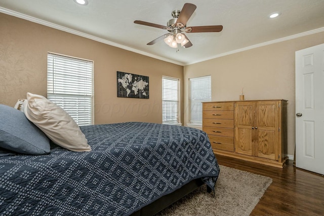 bedroom featuring ceiling fan, ornamental molding, and dark hardwood / wood-style flooring