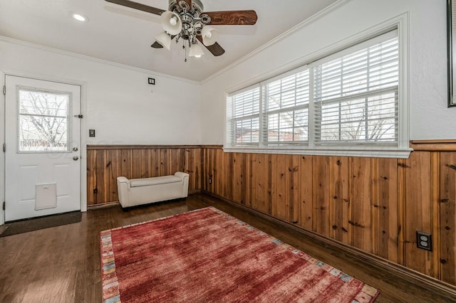 foyer featuring ceiling fan, ornamental molding, and dark hardwood / wood-style flooring