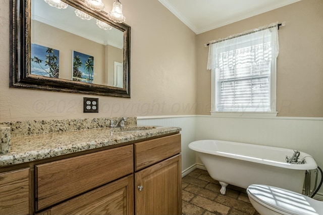 bathroom with vanity, a bathtub, crown molding, and toilet