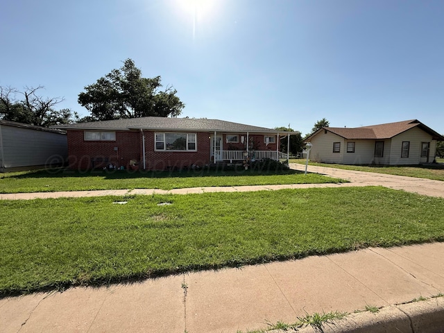 209 N Bowie Ave, Tulia, TX 79088 - ranch-style home featuring a porch, a front lawn, brick siding, and concrete driveway