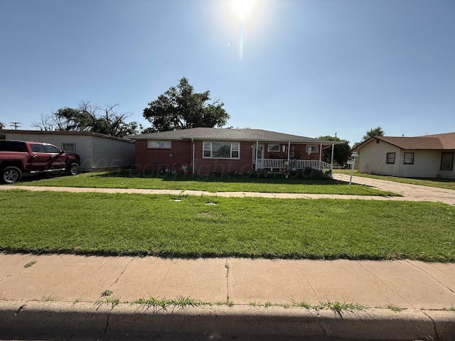 209 N Bowie Ave, Tulia, TX 79088 - ranch-style house featuring a front lawn, covered porch, and brick siding