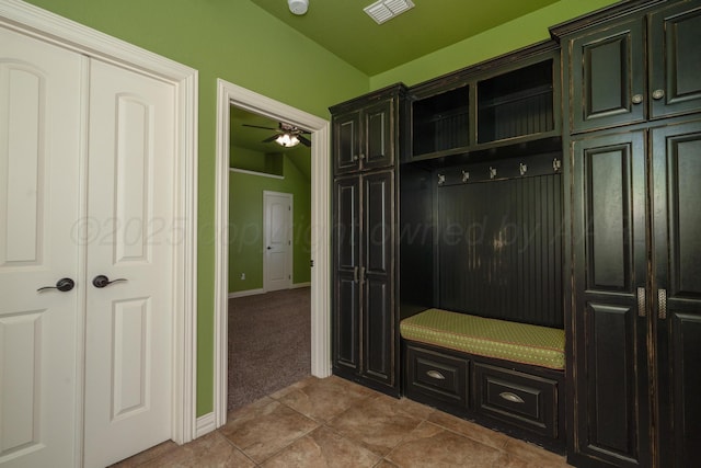 mudroom featuring ceiling fan, visible vents, tile patterned flooring, baseboards, and carpet