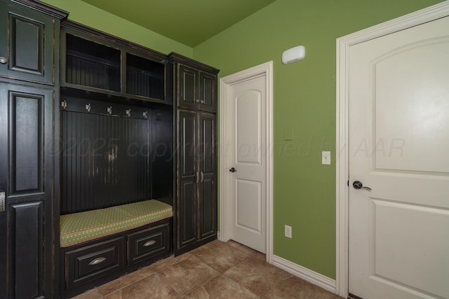 mudroom with baseboards and tile patterned floors