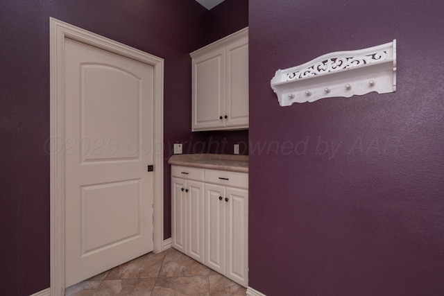 washroom with light tile patterned flooring