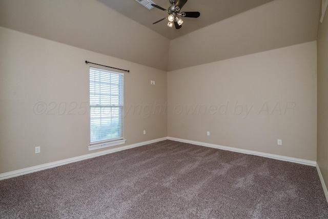 spare room featuring visible vents, dark carpet, baseboards, a ceiling fan, and vaulted ceiling