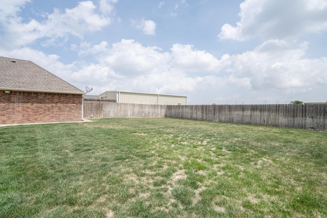 view of yard with a fenced backyard