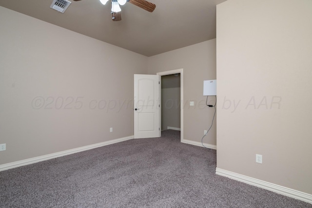 empty room with visible vents, baseboards, ceiling fan, and dark colored carpet